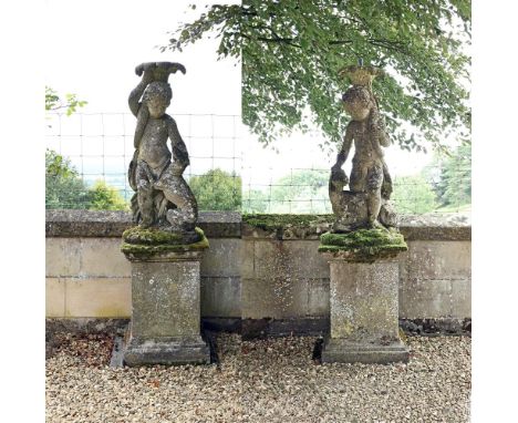 A PAIR OF STONE COMPOSITION FIGURES ON PLINTHS  IN THE MANNER OF AUSTIN & SEELEY, 20TH CENTURY each 170cm high overall, the f