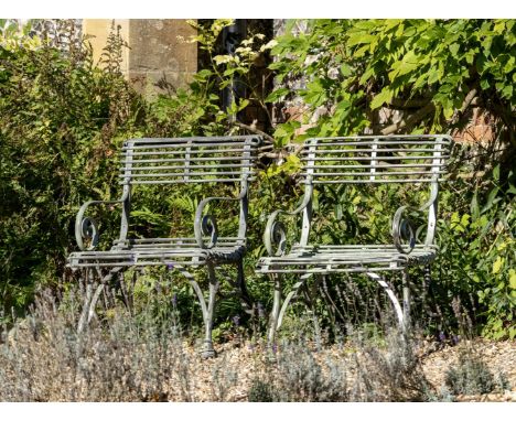 A NEAR PAIR OF FRENCH WROUGHT, CAST AND BENT IRON GARDEN ARMCHAIRS  BY THE SAINT SAUVEUR FACTORY, ARRAS, EARLY 20TH CENTURY  