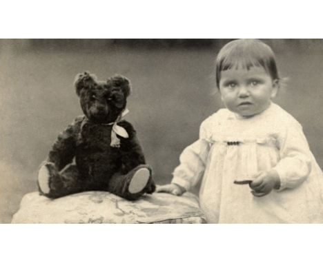 An early 20th century Teddy Bear, originally black, very worn and in poor condition, a photograph from 1913 shows the black b