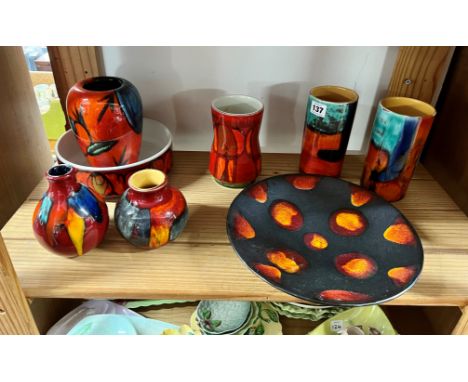 A collection of eight pieces of Poole Pottery including pair of vases, plate etc.