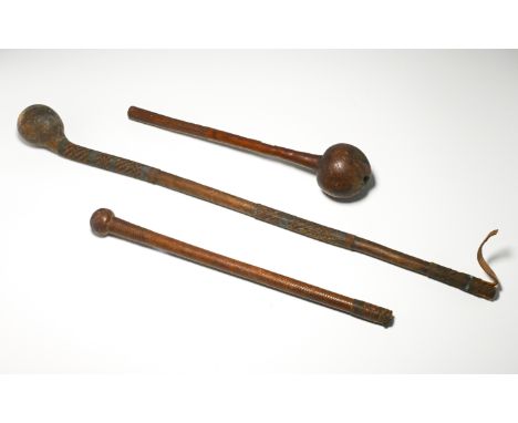 Two African wooden knobkerrie together with a leather knobkerrie (3).