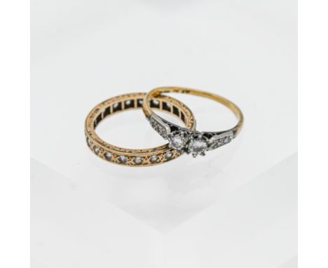 Two rings, 9ct gold, one with a full eternity of stones with diamond effect and one with two large central stones bordered by