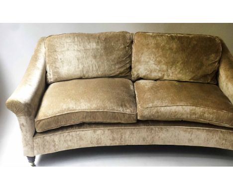 SOFA, bow front oyster velvet upholstered with two feather filled back and seat cushions and turned supports with castors, 19