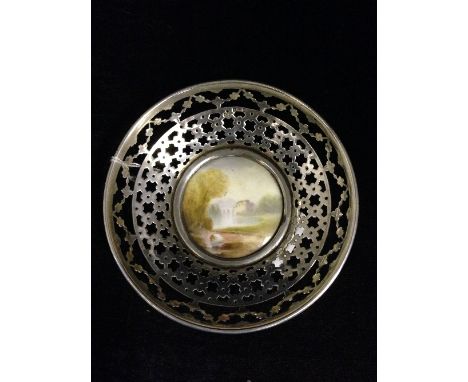 A small circular pierced silver dish with central hand painted Royal Worcester lozenge, decorated with a lake scene.
