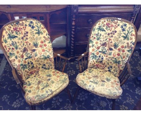 A pair of Ercol Old Colonial armchairs.