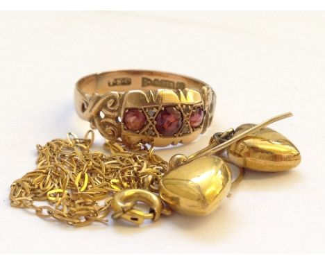 A 9 carat gold ruby set ladies' dress ring together with a pair of 9 carat gold heart earrings and a small chain.