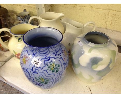 Three modern Poole Pottery jugs together with two vases.