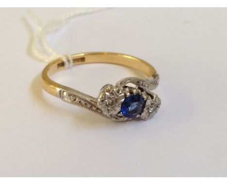 An 18 carat gold and platinum sapphire and diamond set twist ring.