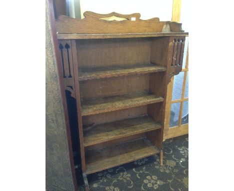 An Arts & Crafts Liberty & Co. style oak four shelf bookcase.