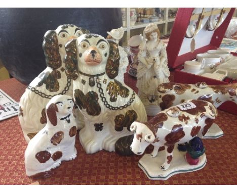 A pair of late 19th century Staffordshire Pottery fireside dog ornaments together with a smaller similar, a pair of Continent