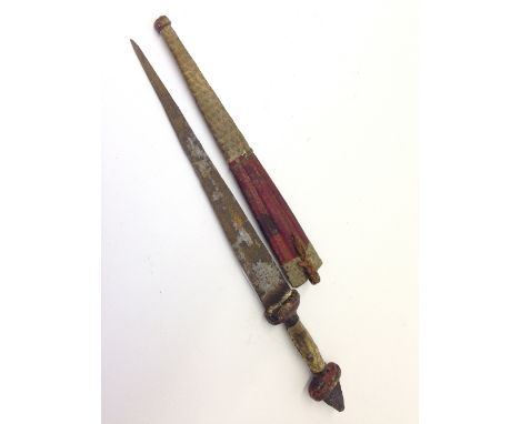 An early 20th century native dagger in snakeskin and leather sheath.