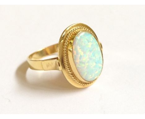 An 18 carat gold ring set with large synthetic opal.