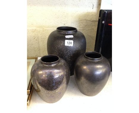 A large Poole Pottery black lustre vase together with a pair of similar smaller vases.