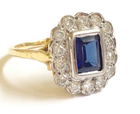 An 18 carat yellow and white gold natural sapphire and 14 diamond set cluster ring.