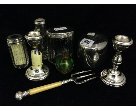 A pair of small silver candlesticks together with two silver lidded dressing table jars, a small engraved glass specimen vase