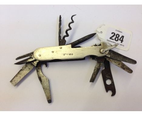 A Swiss Army knife with silver hallmarked outer case (two blades af).