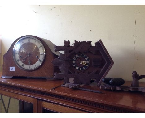 A Westminster Chime oak cased mantle clock together with a cuckoo clock.