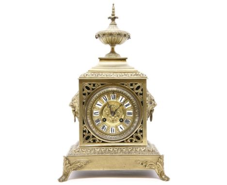 A late 19th century French brass mantel clock, with lion's mask handles, and drum movement, striking on a bell, 39cm high