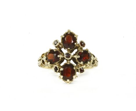 A 9ct gold four stone garnet cluster ring, finger size K½,3.74g