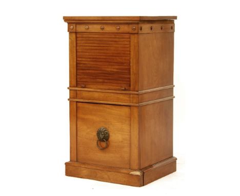 A 19th century satin walnut commode cabinet, with a roller shutter above a drawer with lion's mask handle, stamped 'C. Hindle