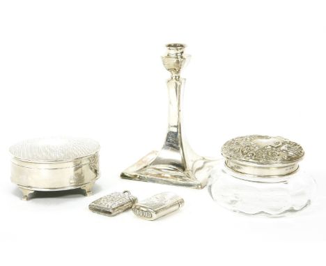 A collection of silver dressing table items, a candlestick and two vesta cases