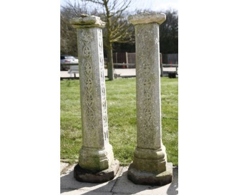 A pair of Arts and Crafts stone plinths, of tapering form and decorated with Celtic motifs, 115cm tall