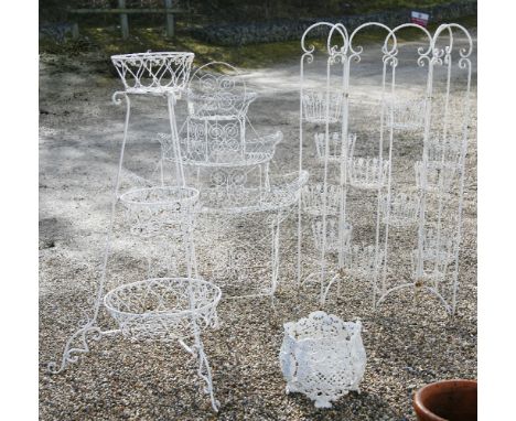 A pair of white painted metal planters, with wore work baskets, height 145 cm, together with a graduated planter, one other a
