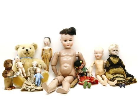 A German bisque headed doll stamped Wally 6 1/2, together with a small collection of dolls and a Pelham puppet