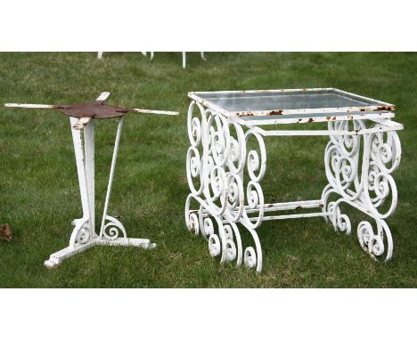 An Art Deco iron table base, together with a nest of glass topped garden tables, with scrolling supports, 51cm x 35cm x 47cm