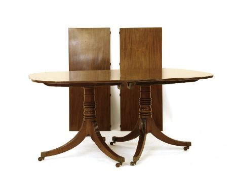 A Georgian style mahogany D-end extending dining table, the top on turned supports, sabre legs and brass casters, 114cm wide,