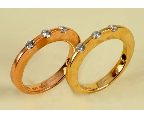 A pair of contemporary Diamond three stone Rings each channel-set three brilliant-cut diamonds in 18ct gold, red stone set to