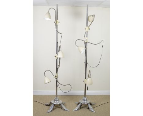 A pair of chrome three light Stiletto Floor Lamps on four stylised lady's heeled shoe supports