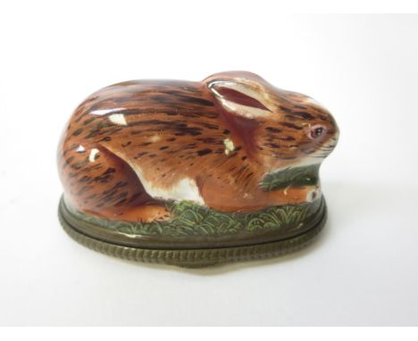 A Bilston enamel Bonbonniere in the form of a rabbit, the hinged lid painted Aesop Fable animals, A/F