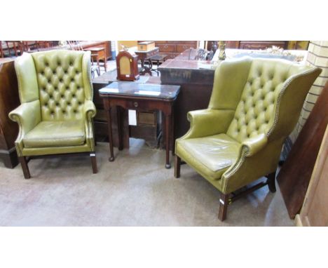 A pair of Georgian style Wing Armchairs with green leather button upholstery on moulded square mahogany front legs united by 