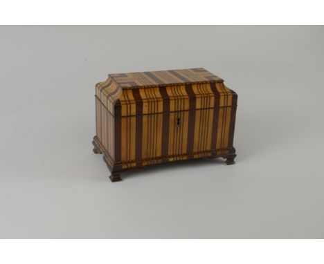 A Georgian Tea Caddy of sarcophagus form in vertical bands of satinwood, mahogany, etc three interior divisions on ogee brack