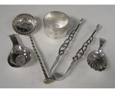 Two Georgian silver Caddy Spoons, one with filigree bowl, a pair of Chippendale design Sugar Tongs with acorn finial, Coronat