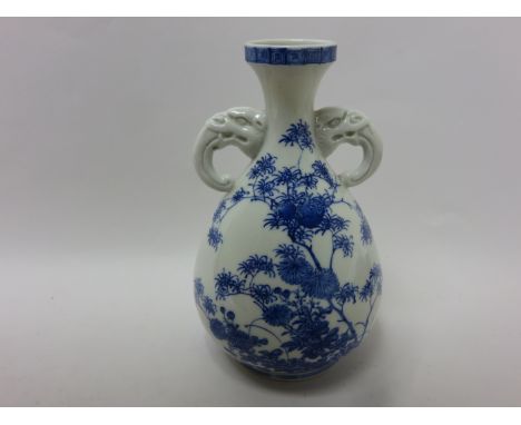 A Japanese porcelain blue and white baluster Vase painted flowering shrubs, elephant mask and trunk handles, 9in, three chara