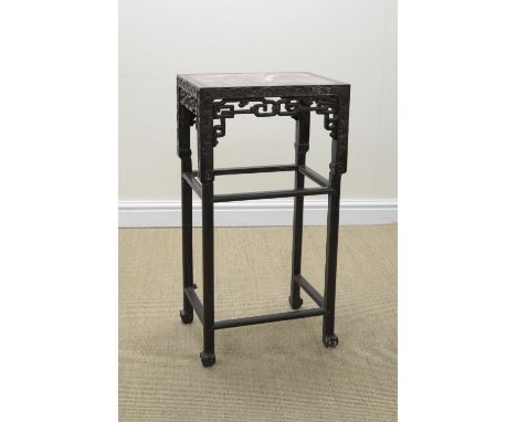 A 19th Century Chinese hardwood Vase Stand with inset veined marble top on squared supports with leafage scroll carved frieze