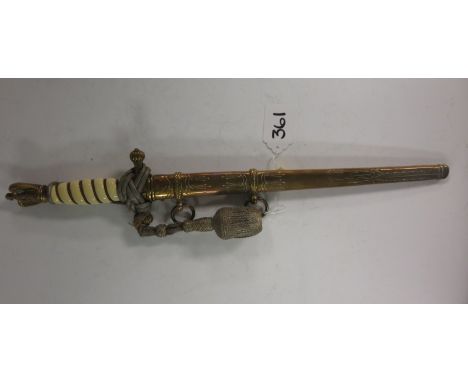 A German Kriegsmarine Dress Dagger, Lufteagle brass hilt and blade stamped W.K.C., with an engraved brass scabbard AMENDMENT 