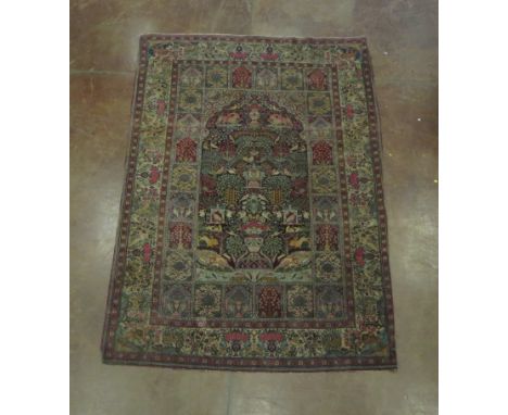 A small Tabriz bordered Carpet with central field of birds, lions, monkeys, foxes, fish etc on a dark blue ground, inner bord