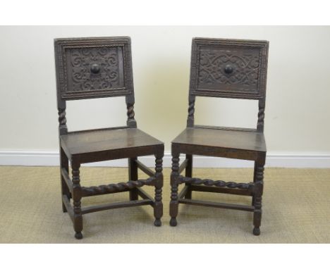A Set of six late 17th Century oak Chairs with scroll carved panel backs, solid seats on turned and square front legs, spiral