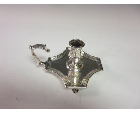 A George IV silver shaped square Chamber Candlestick engraved crowned crest, scroll handle and feet, London 1822, maker: R. G