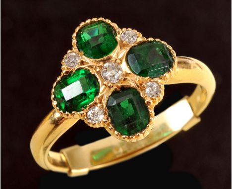 An Edwardian Emerald and Diamond quatrefoil Ring pav-set four step-cut emeralds interspersed with five old-cut diamonds in 18