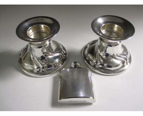 A modern silver Hip Flask with engine turning, Birmingham 1969, and a pair of modern sterling silver dumpy Candlesticks on ci