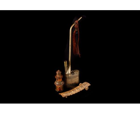A nickel silver opium pipe, together with a painted treen multi-sectional spice jar, and a bone cribbage board (3) 