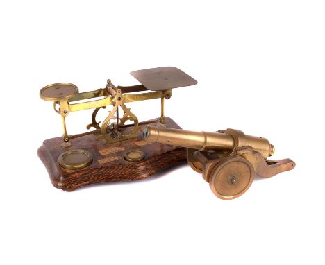 A piece of trench art in the form of a cannon, together with a pair of postal scales with a set of graduated weights 