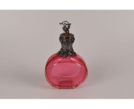 A white metal mounted cranberry glass moon flask, with hanging grape finial to the vine decorated lid surmounts a rococo brig