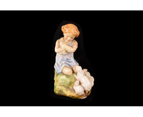 A Royal Worcester porcelain figure by Doughty, entitled 'My Favourite', modelled as a young girl holding a rabbit with many o