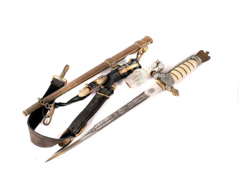 A WWII Kriegsmarine dagger, having eagle and swastika pommel, wire wound ivorine hand grip and brass hand guard, leading to E