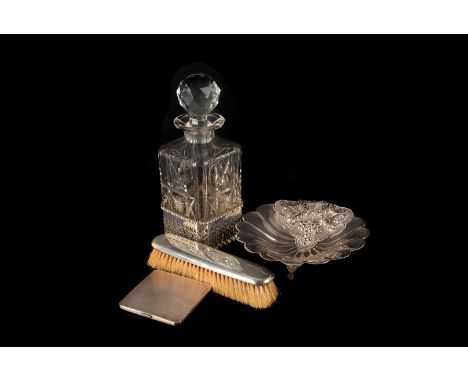 A George V cut glass decanter in silver stand, together with three silver backed dressing table items, a silver photograph fr